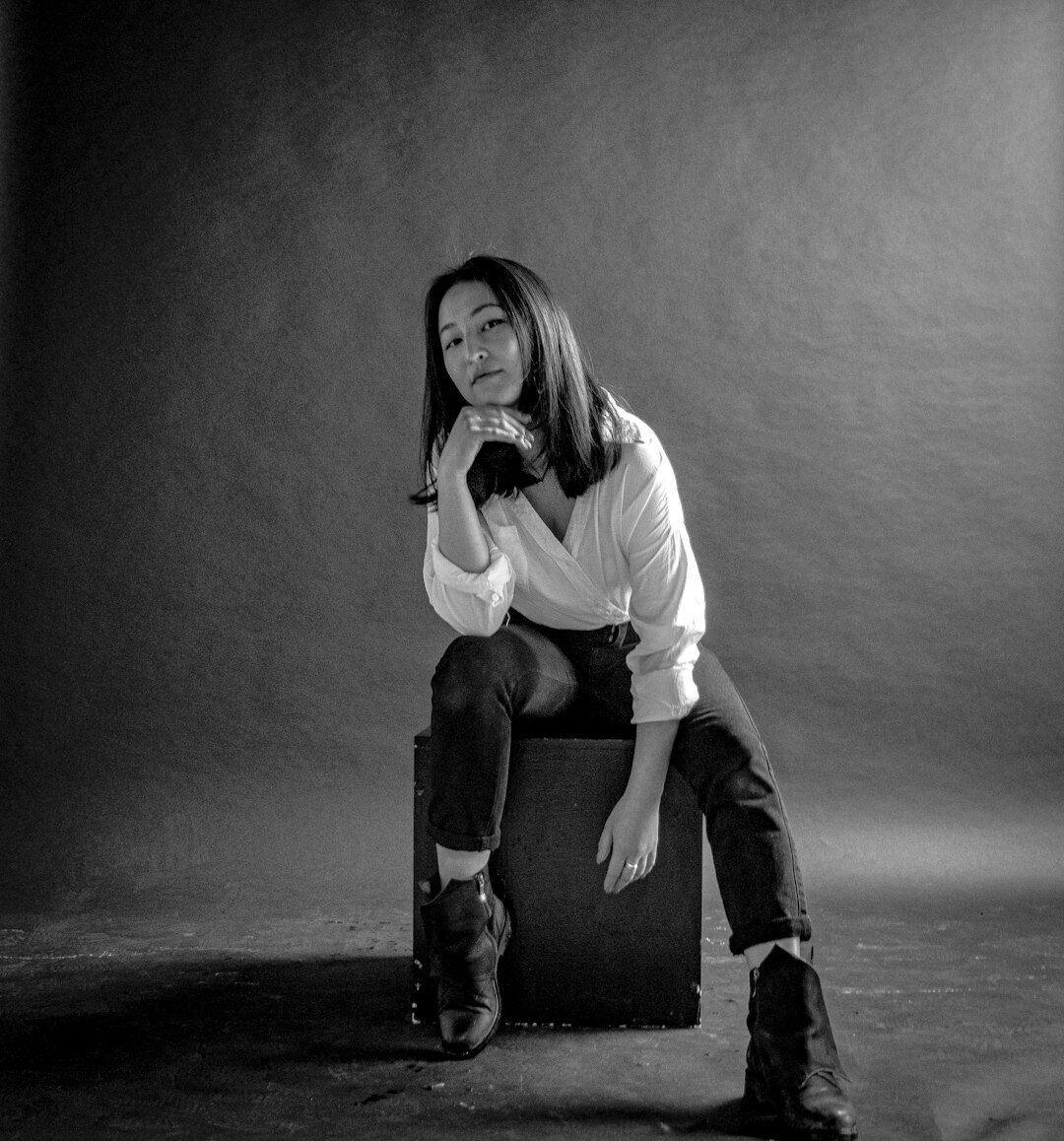 Studio portrait of the photography director, a woman in her thirties
