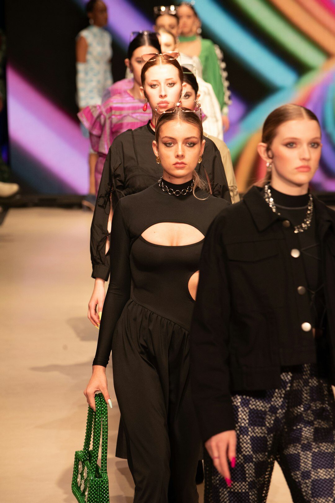 Backstage at a fashion week runway show with models in preparation